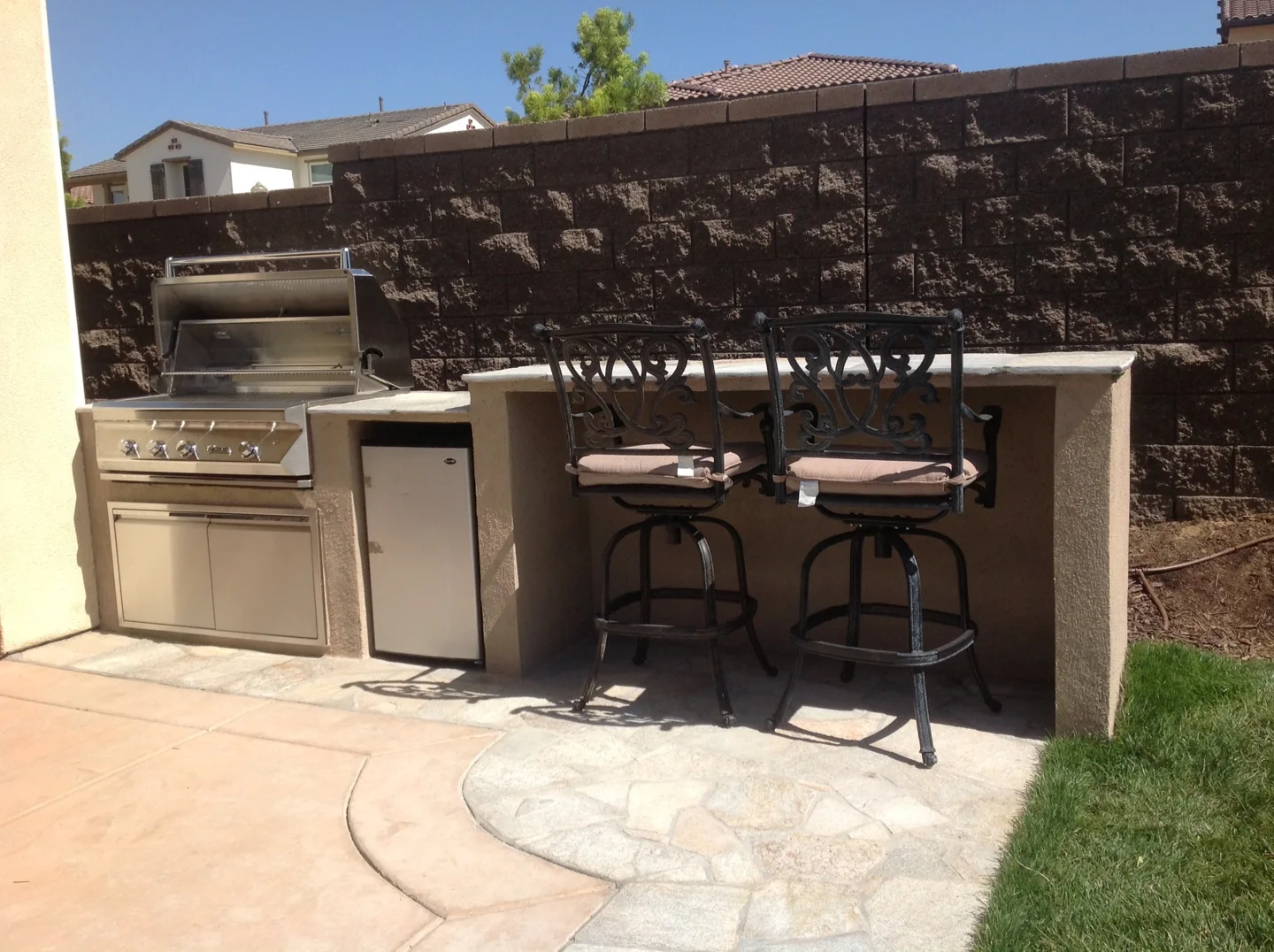 An outdoor kitchen beside the patio