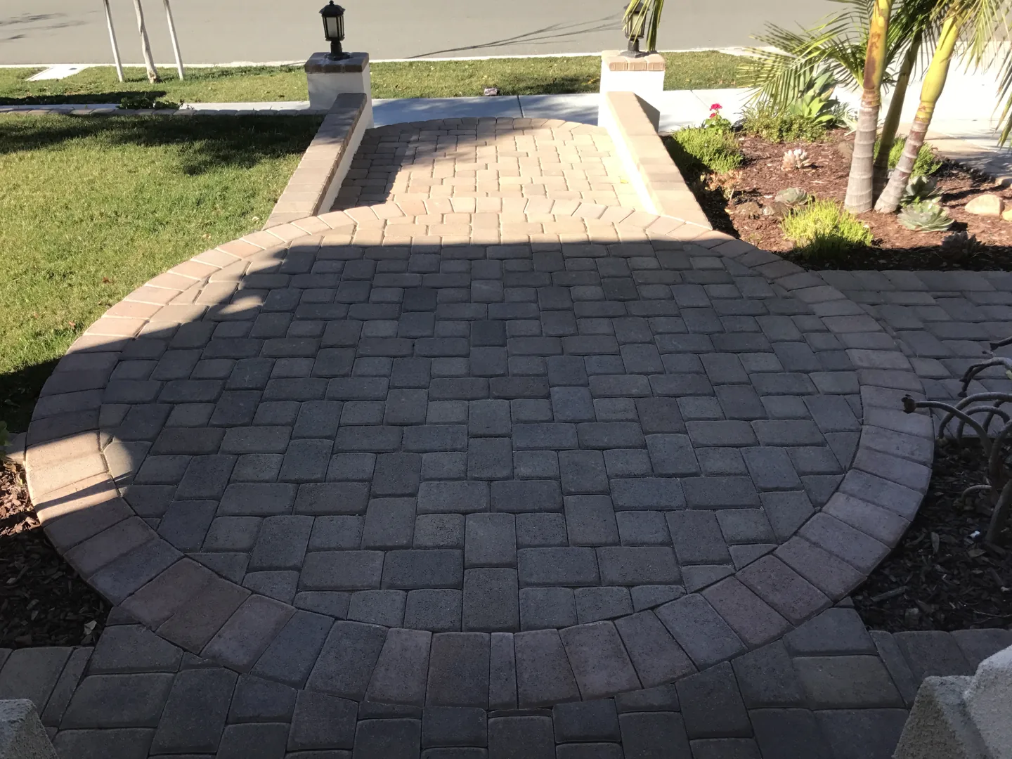 A paved walkway beside the house