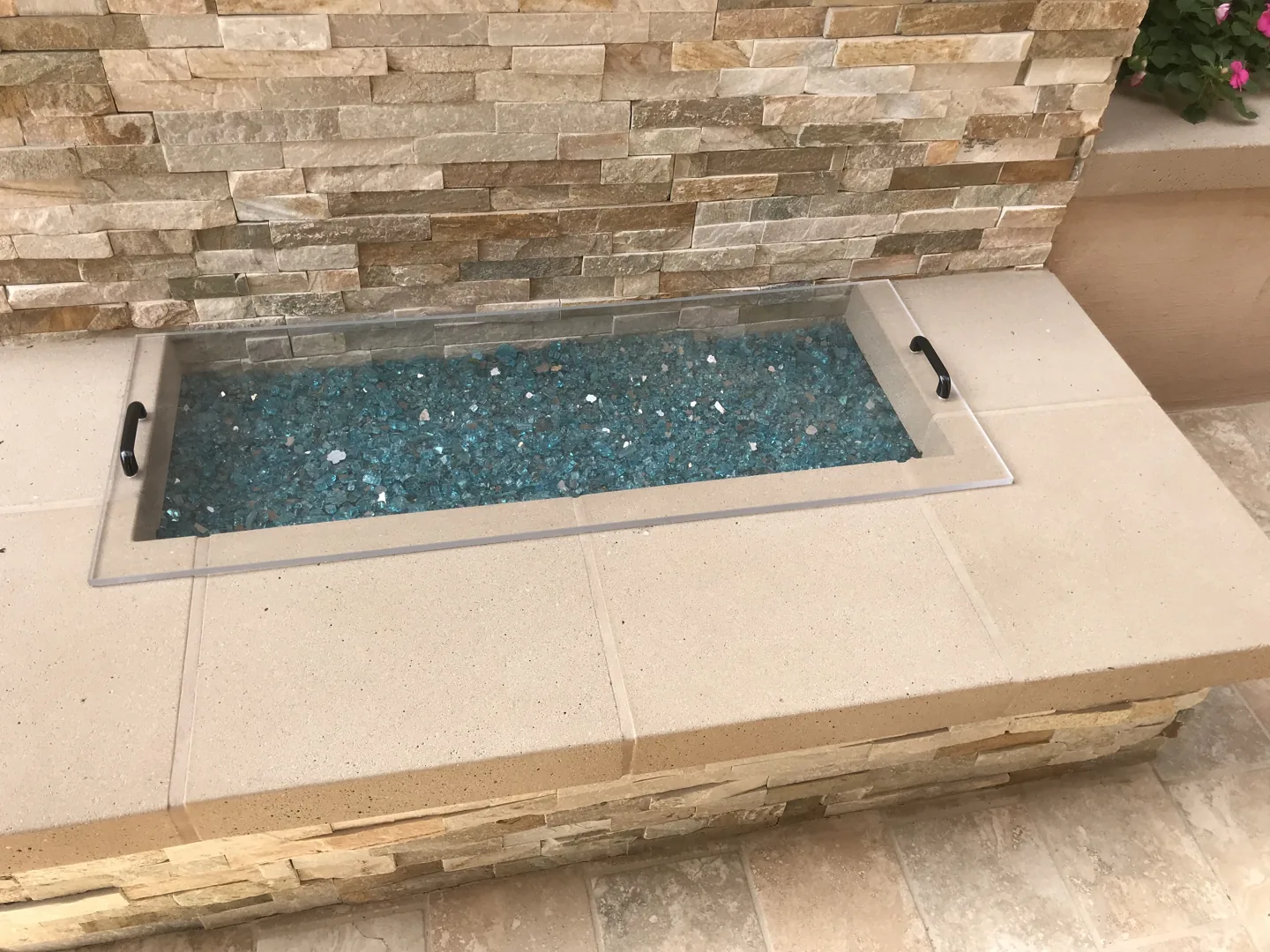 A rectangular fire pit with glass detail