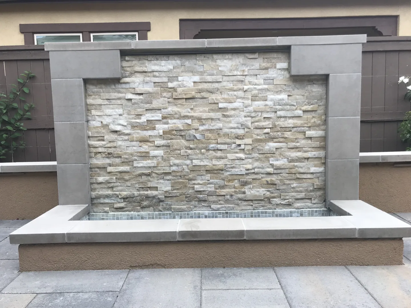 A pale stone water wall