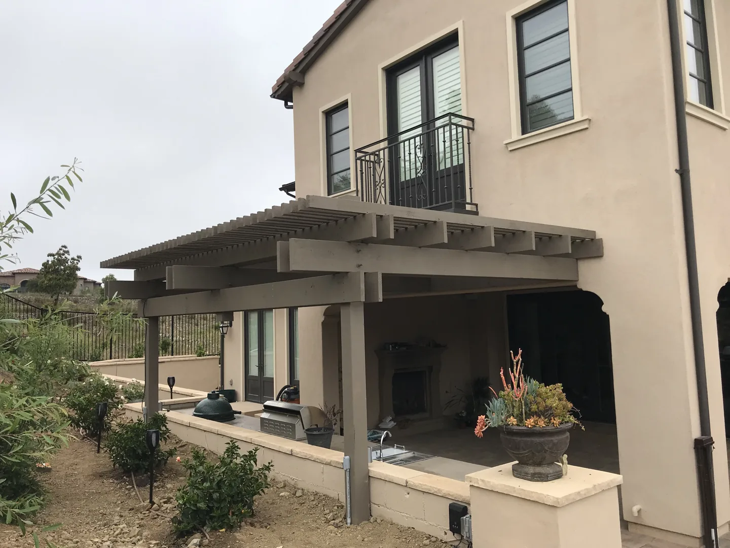 A timber pergola above the outdoor kitchen