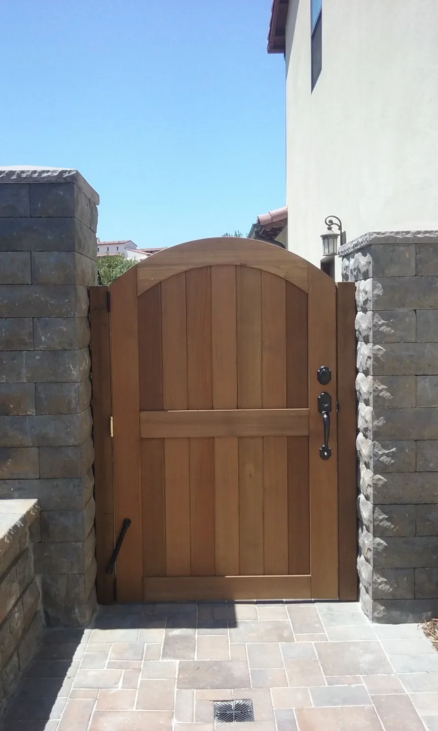 A timber gate between garden walls